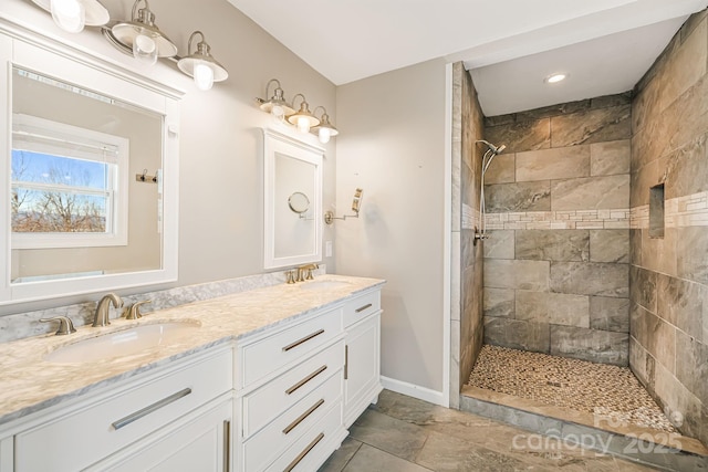 bathroom featuring vanity and tiled shower