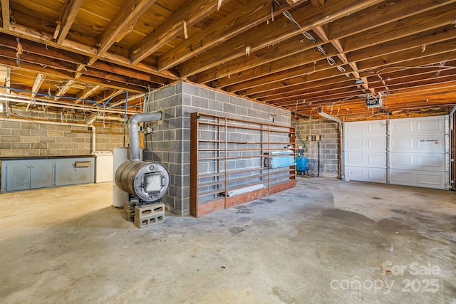 garage with a garage door opener and washer / dryer