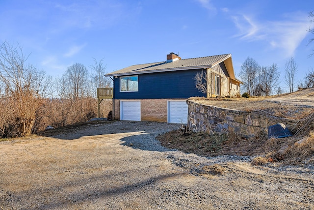 view of home's exterior featuring a garage and a deck