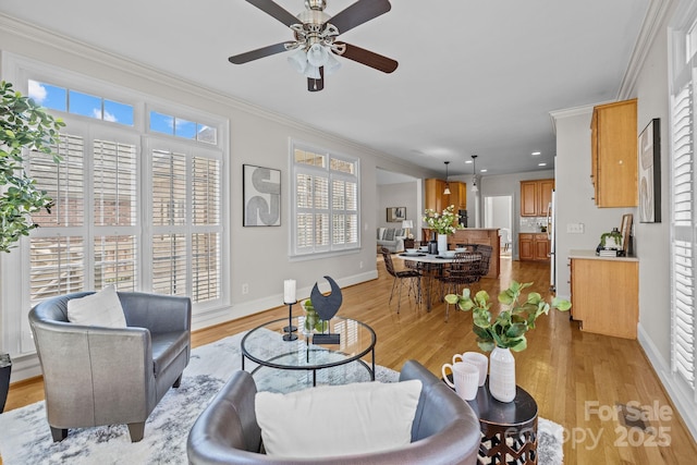 living room with light hardwood / wood-style floors, plenty of natural light, ornamental molding, and ceiling fan