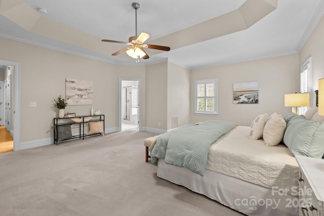 bedroom featuring a tray ceiling, ceiling fan, crown molding, and light colored carpet