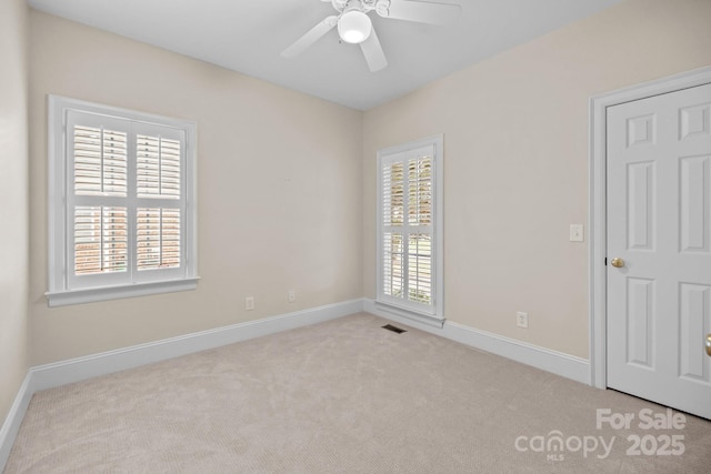 carpeted empty room featuring ceiling fan