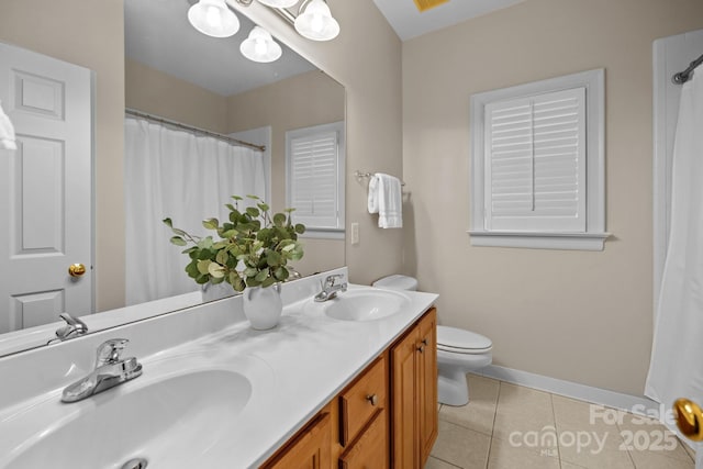 bathroom featuring tile patterned flooring, vanity, and toilet