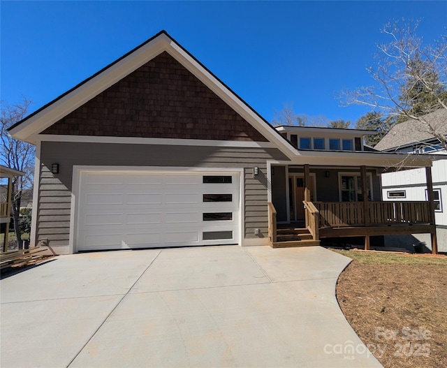 ranch-style home featuring a porch, concrete driveway, and an attached garage