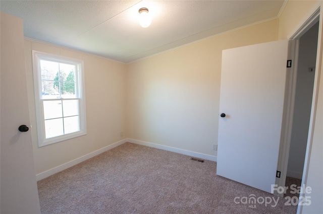 carpeted empty room with ornamental molding