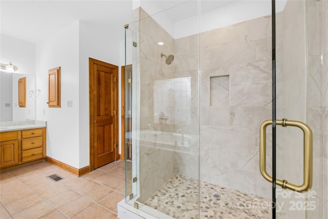 bathroom featuring tile patterned floors, vanity, and an enclosed shower