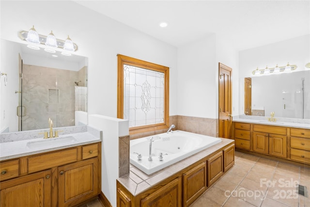 bathroom featuring tile patterned floors, plus walk in shower, and vanity