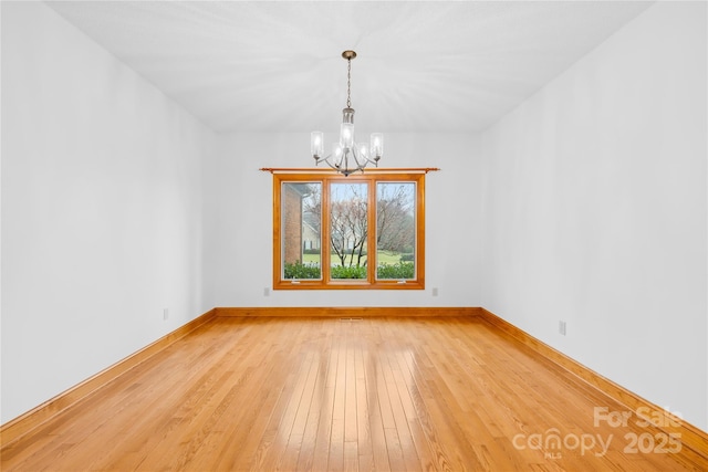 unfurnished dining area featuring hardwood / wood-style flooring and a chandelier