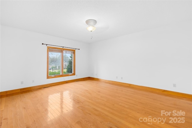 empty room with wood-type flooring