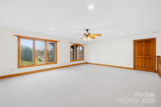 unfurnished room featuring ceiling fan and light colored carpet