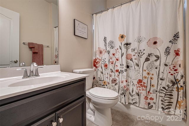 bathroom with tile patterned flooring, vanity, and toilet