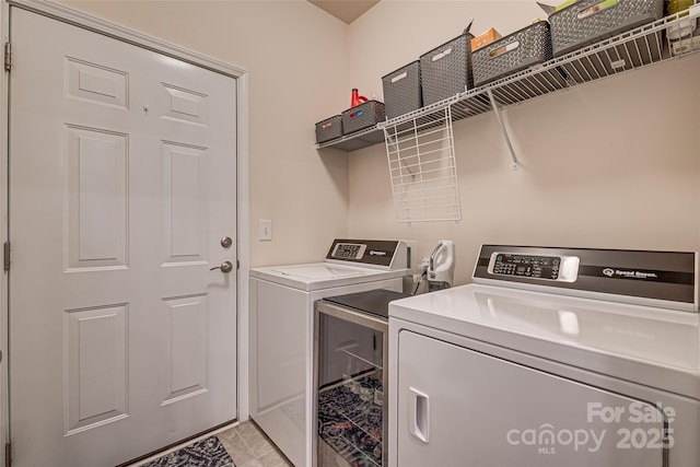 washroom with washer and dryer and light tile patterned flooring