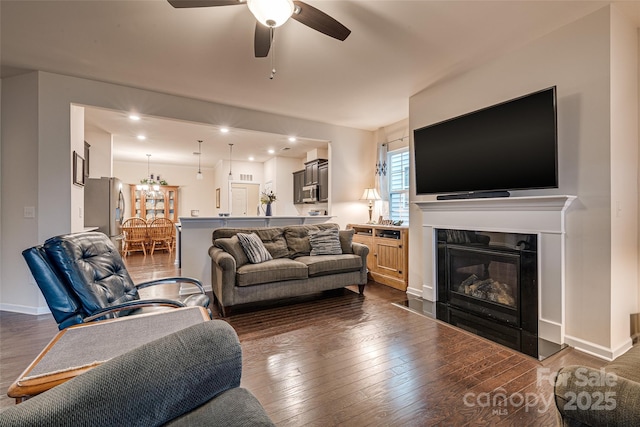 living room featuring dark hardwood / wood-style floors and ceiling fan