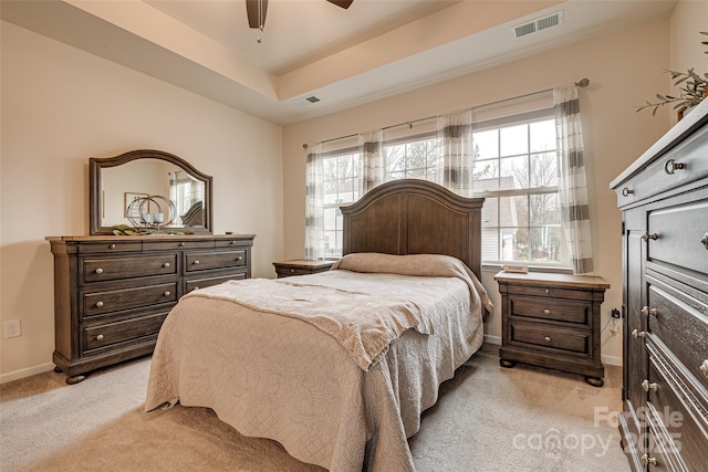 bedroom with ceiling fan, light carpet, and multiple windows