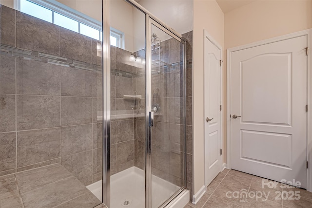 bathroom with tile patterned flooring and an enclosed shower