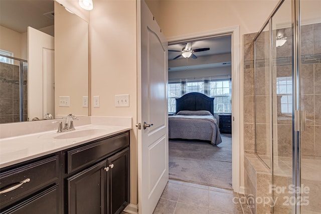 bathroom with tile patterned floors, ceiling fan, vanity, and a shower with shower door