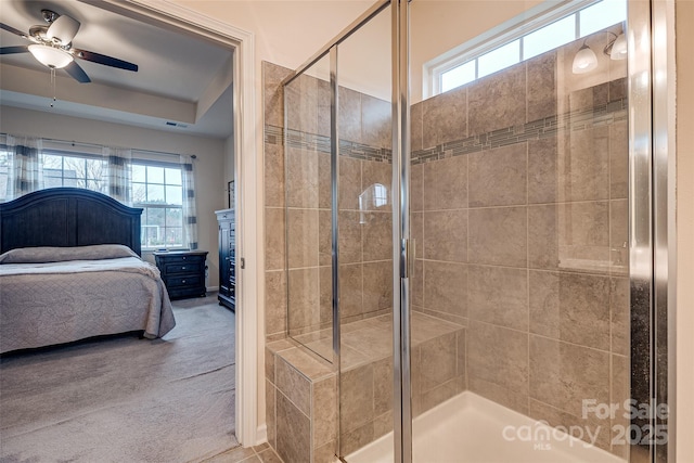 bathroom with ceiling fan and an enclosed shower