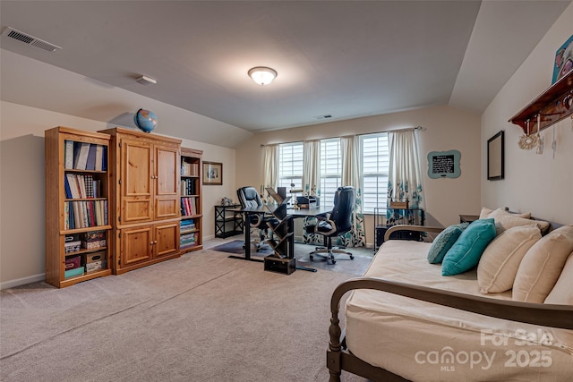 bedroom with light colored carpet and lofted ceiling