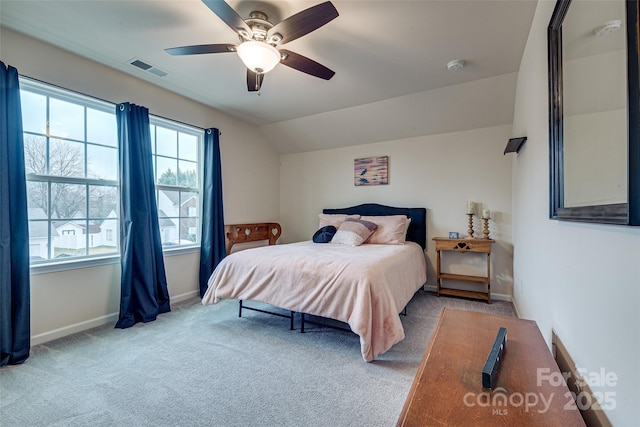 carpeted bedroom with ceiling fan and vaulted ceiling