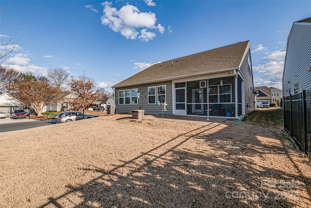 back of property with a sunroom