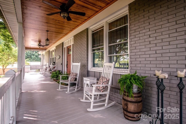 deck with a porch and ceiling fan