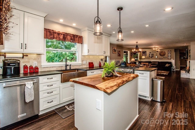 kitchen with white cabinetry, dishwasher, and a center island