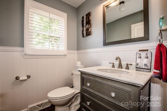 bathroom featuring vanity and toilet