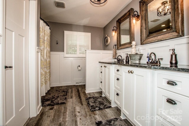 bathroom with hardwood / wood-style floors and vanity