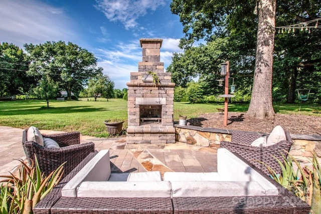 view of patio featuring an outdoor stone fireplace