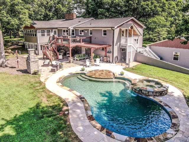 view of swimming pool featuring an in ground hot tub, a lawn, a patio area, and a wooden deck