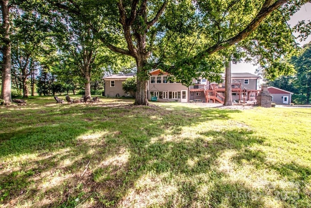 view of yard featuring a wooden deck