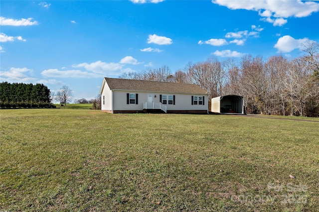 back of house with a carport and a lawn