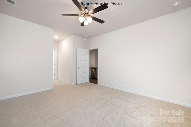 unfurnished room with ceiling fan and light colored carpet