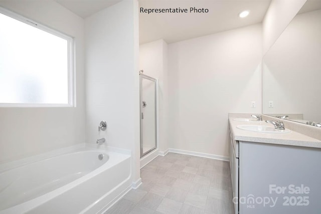 bathroom featuring vanity, shower with separate bathtub, and a wealth of natural light