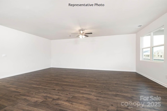 spare room featuring ceiling fan and dark hardwood / wood-style flooring