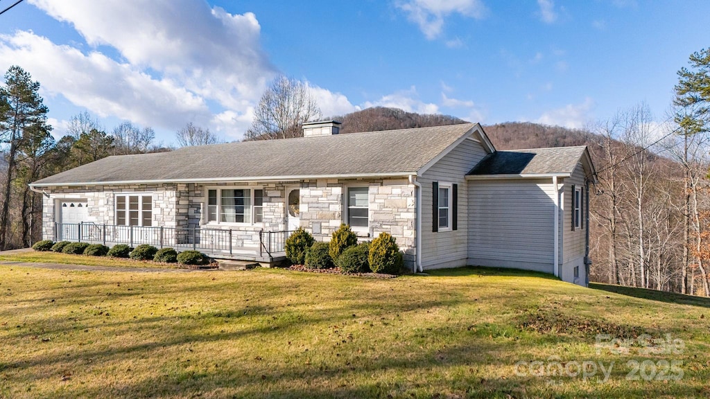 ranch-style home with a front yard and a garage