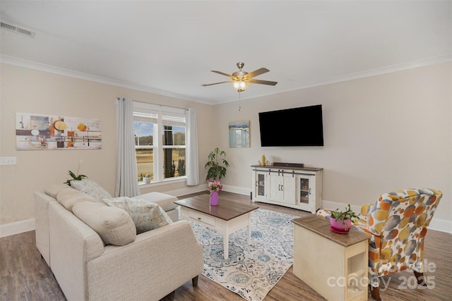 living room with ceiling fan, ornamental molding, and dark hardwood / wood-style floors