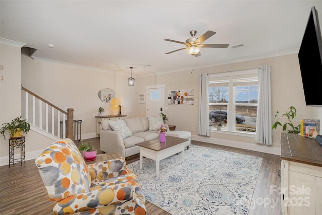 living room with dark wood-type flooring, ceiling fan, and ornamental molding