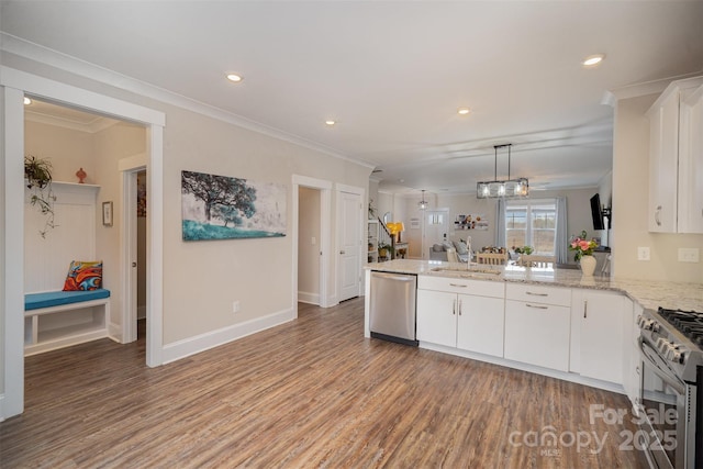 kitchen featuring sink, appliances with stainless steel finishes, white cabinetry, hanging light fixtures, and kitchen peninsula