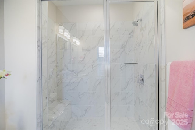 bathroom featuring a shower with shower door