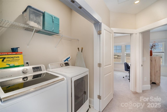 laundry area featuring light carpet and washing machine and clothes dryer