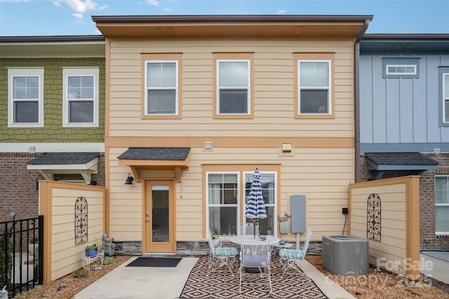 back of house featuring a patio area and central air condition unit