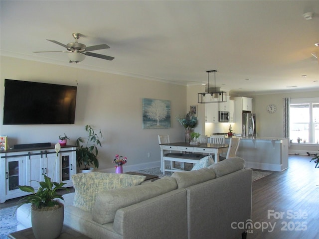 living room featuring ornamental molding, hardwood / wood-style floors, and ceiling fan