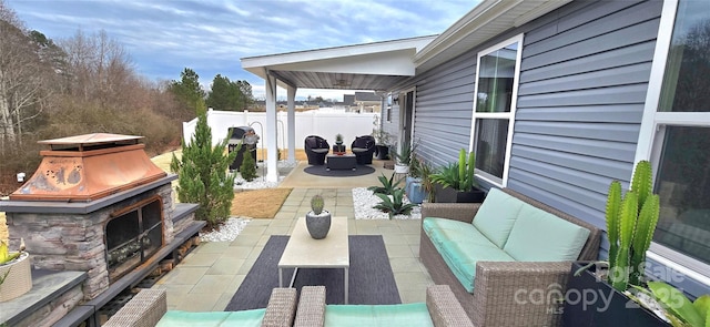 view of patio / terrace featuring an outdoor living space with a fireplace