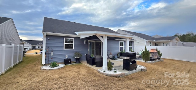 rear view of property featuring a patio area and a lawn