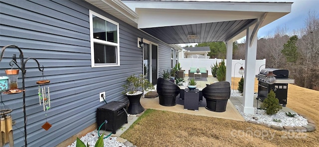 view of patio / terrace with a grill and fence