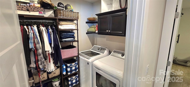 clothes washing area featuring cabinets and washing machine and clothes dryer