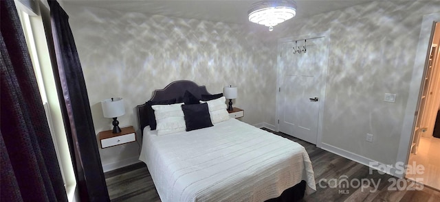 bedroom with dark wood-style flooring and baseboards