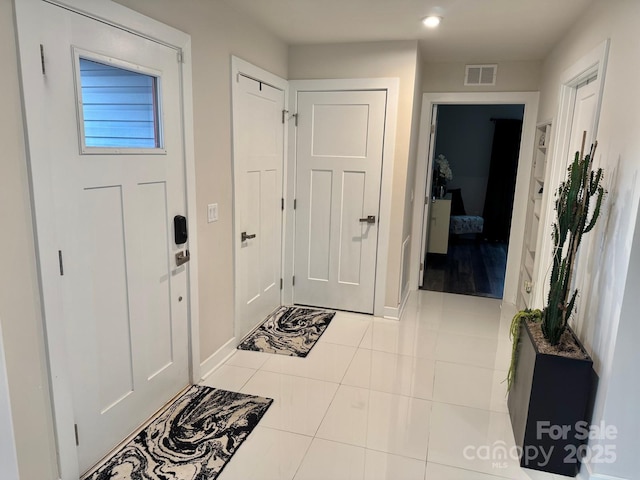 entrance foyer with visible vents, baseboards, and light tile patterned floors