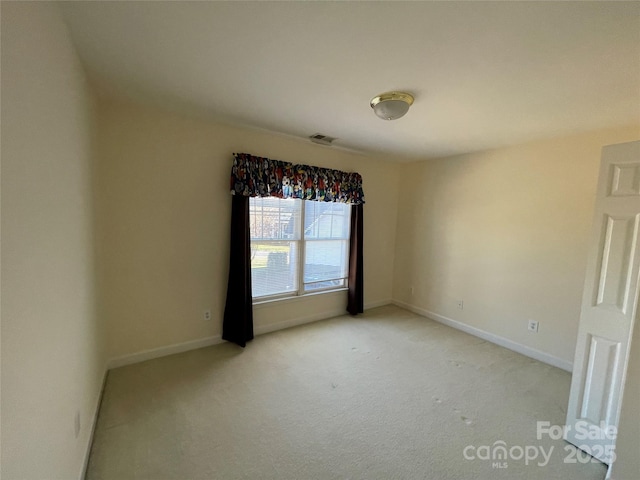 spare room with light colored carpet